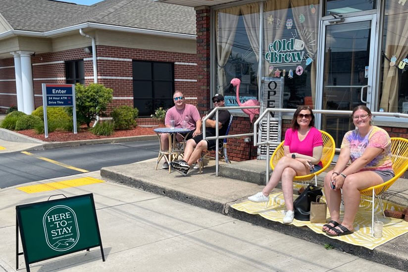 couple sitting in front of the old brew store