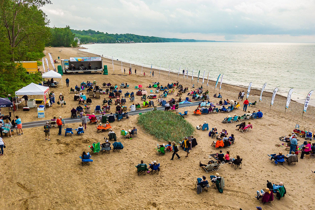 people enjoying sunset concert on beach by Lake erie