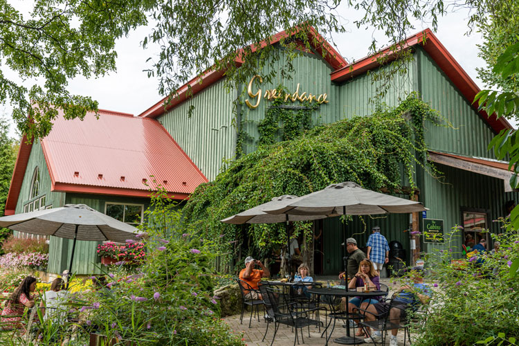 A group of people sitting outside a Winery