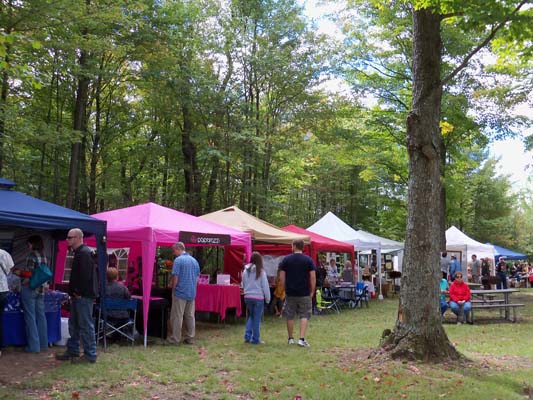 vendor stall tents at Fall Festival in the woods