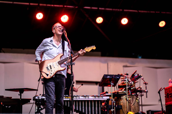 person playing guitar on stage