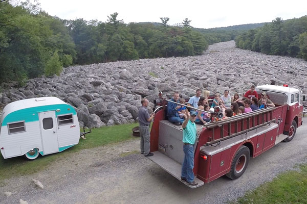 people sitting in the back of a wagon