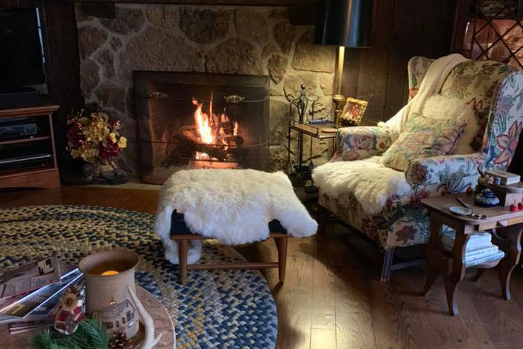 Cozy chair infront of Fireplace inside house