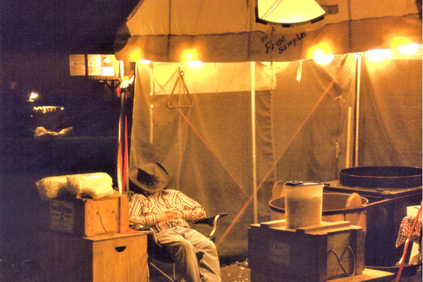 Camper sleeping in chair next to camp