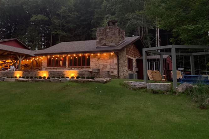 Clarion River Lodge under lights at night