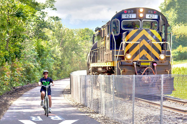 kid cycling next to train McClintock Trail