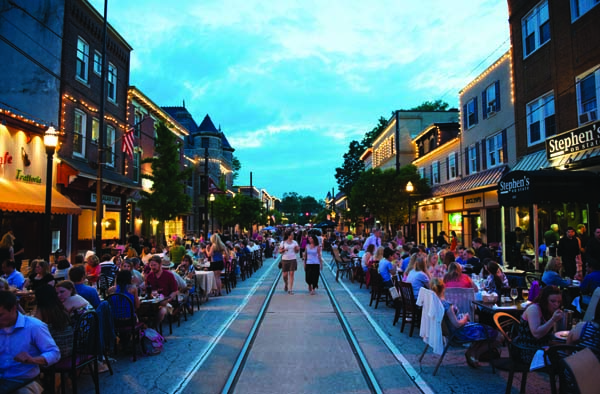 people dining on main street by restaurants