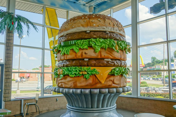 A large hamburger in a glass container