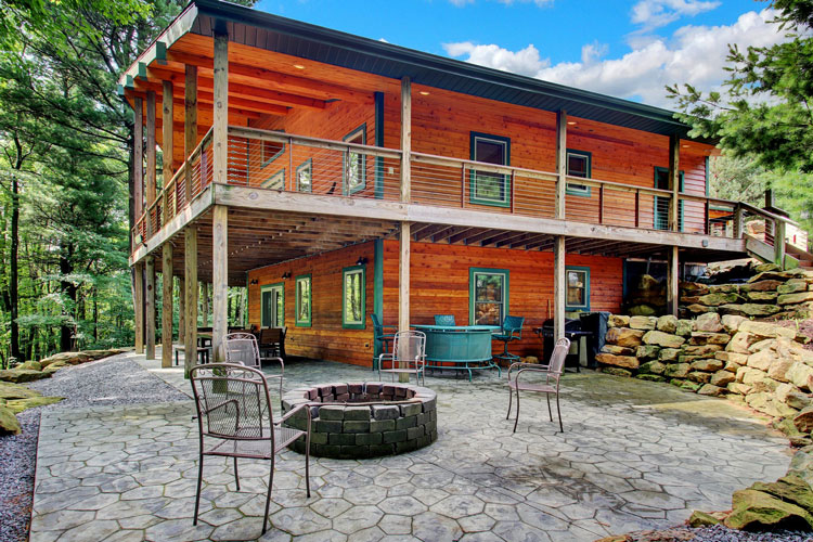 Wood log cabin with firepit infront of Cabin