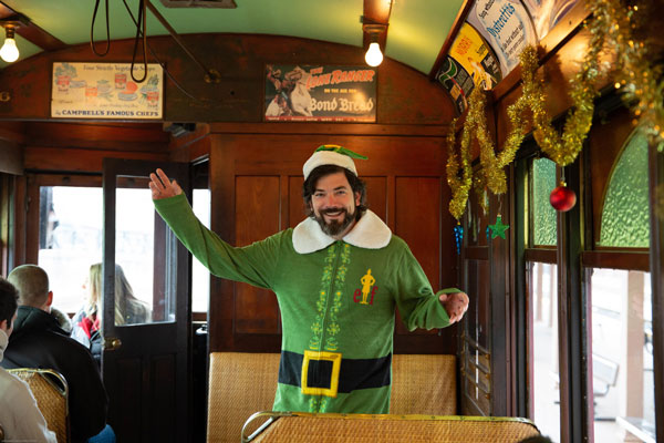 guy dressed as Elf inside Trolly ride