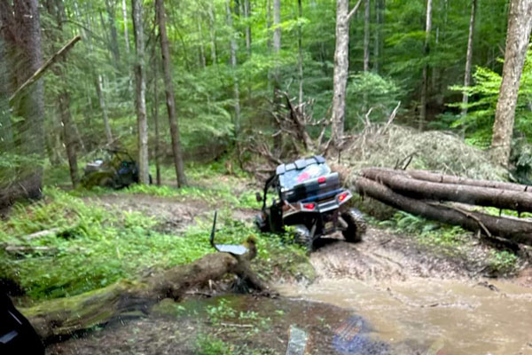 ATV riding thru Trails in the woods