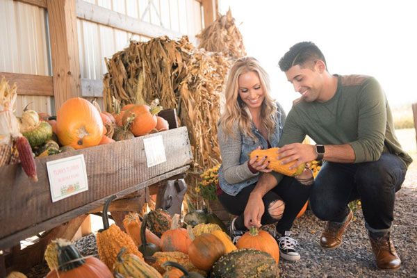 couple holding a pumpkin together