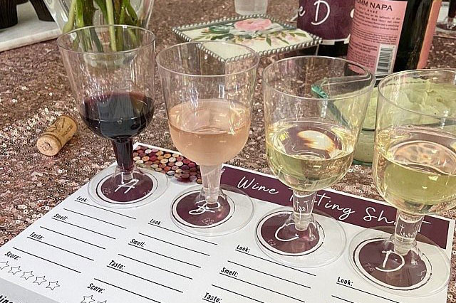 wine tasting glasses placed on top of a paper