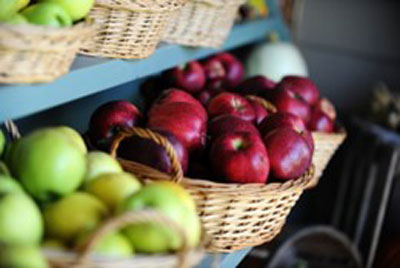Green and red apples in baskets
