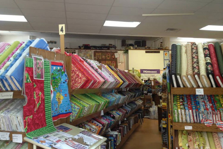 A store with shelves of Quilts