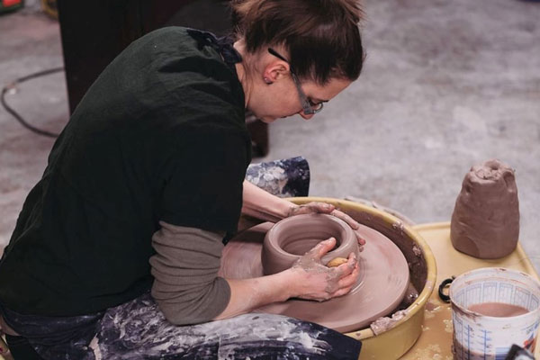 women working on pottery