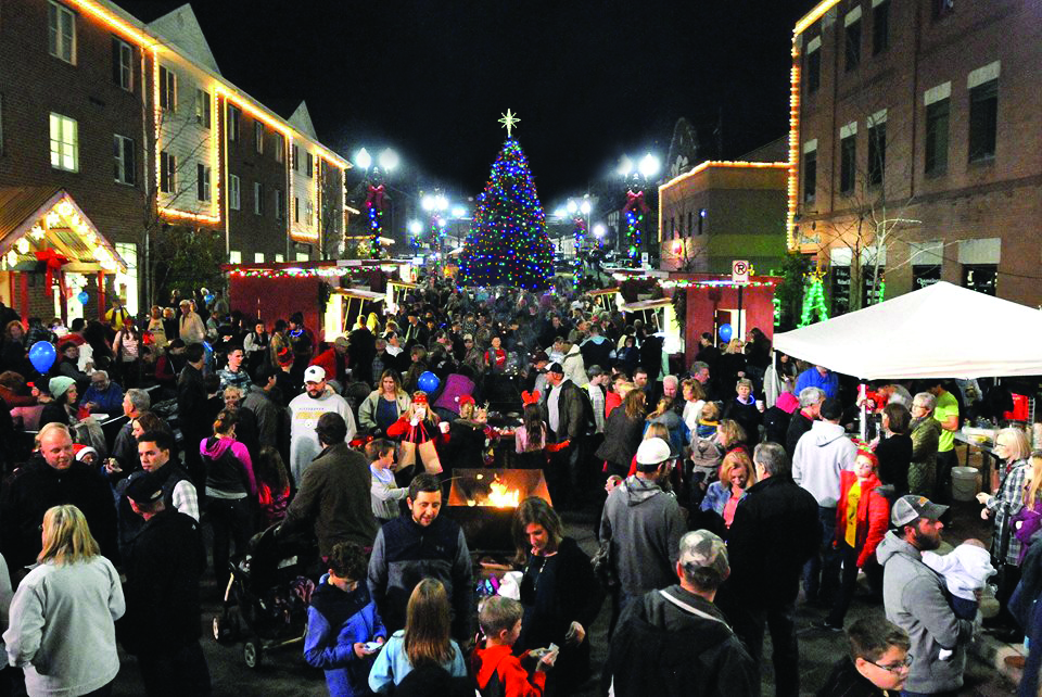 Group of People on main street Holiday Lights around Christmas Tree