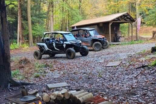 Two ATVs parked infront of the Cabin
