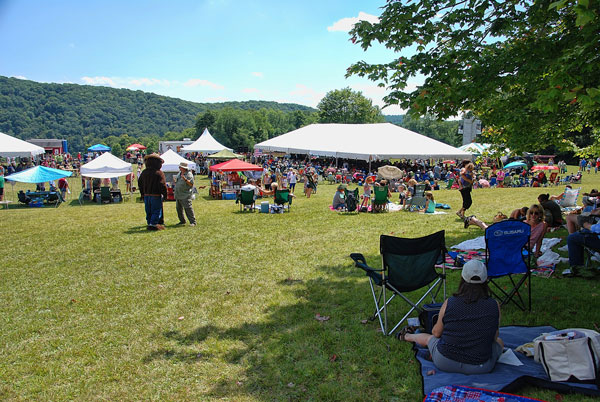 people under tents at Bluegrass festival