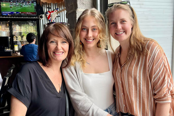 three ladies posing for a photo