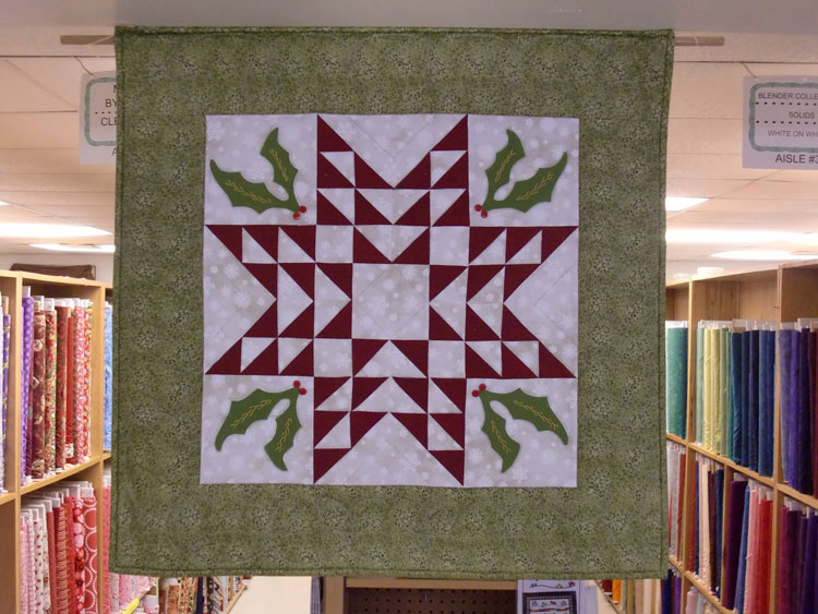 A Quilt hanging from roof inside store