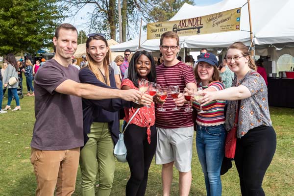 group of young people cheering with Wine glasses