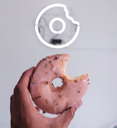 holding donut half bite