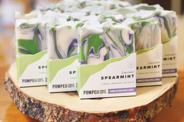 spearmint soaps placed on wooden block inside store