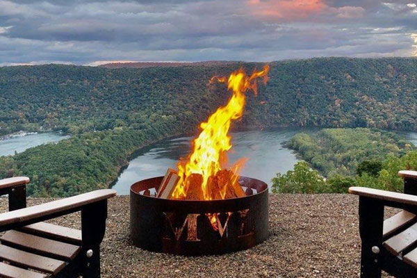 campfire by cabin with stunning view of mountains