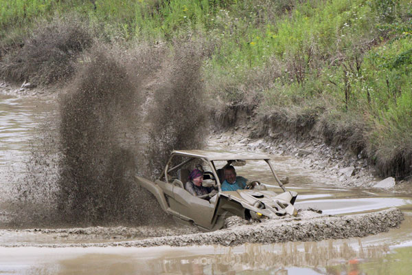 Riding ATV thru Wet muddy Trails