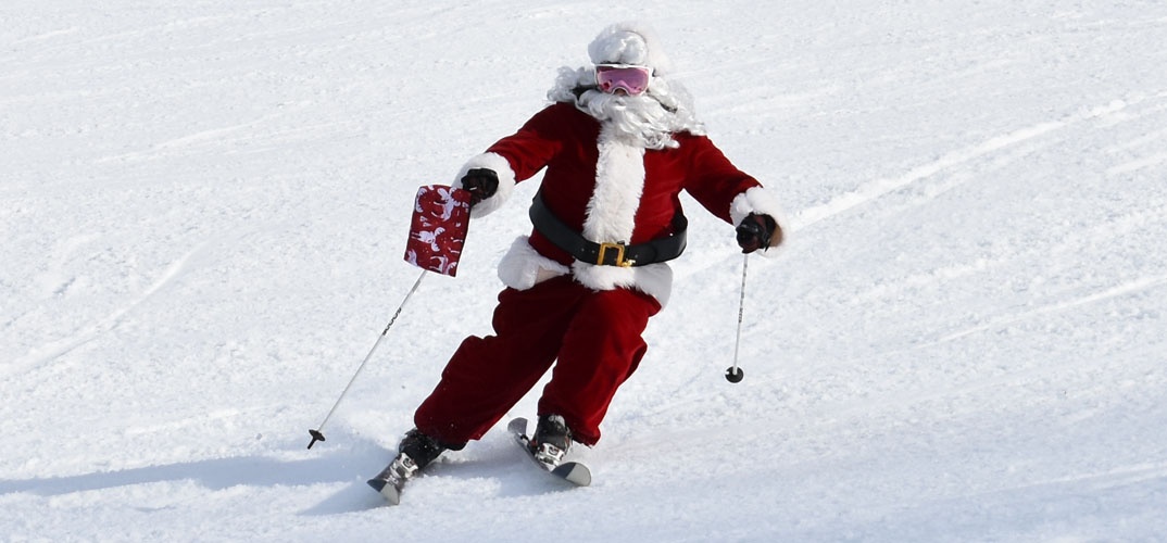 Santa Claus skiing down a hill
