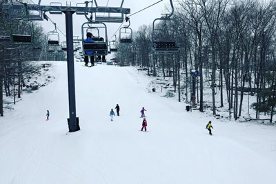 High Chair lift and people skiing around