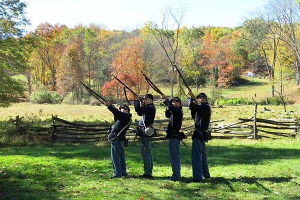 civil war reenactment soldiers firing in air