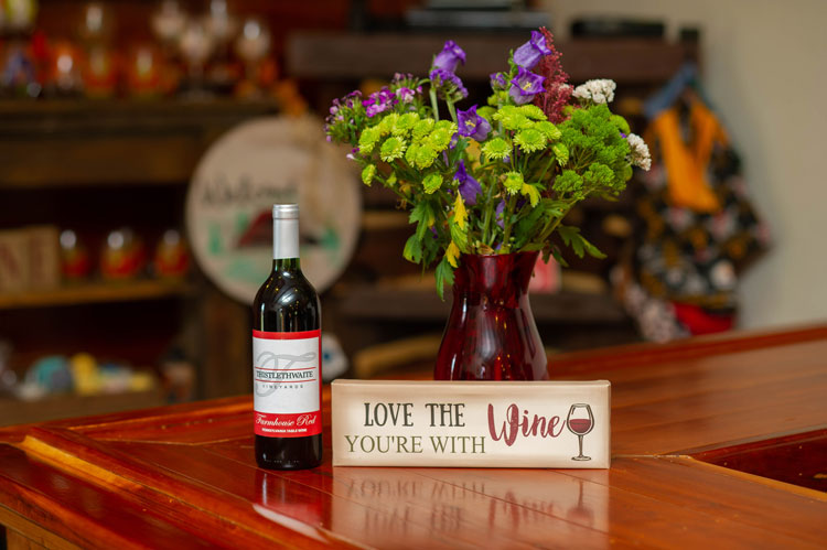 wine bottle on table with flower vase