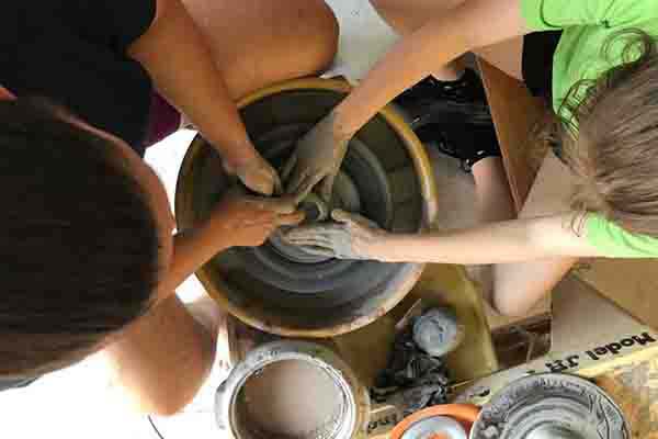 A group of people doing pottery