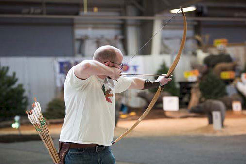 a person aiming arrow
