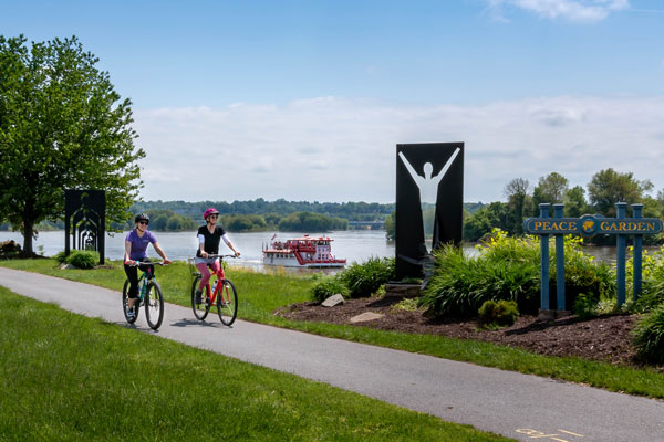 two girls biking on river front