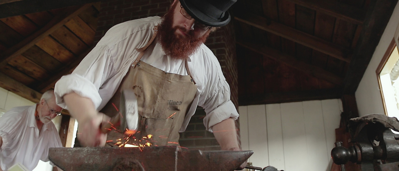 blacksmith with long beard working