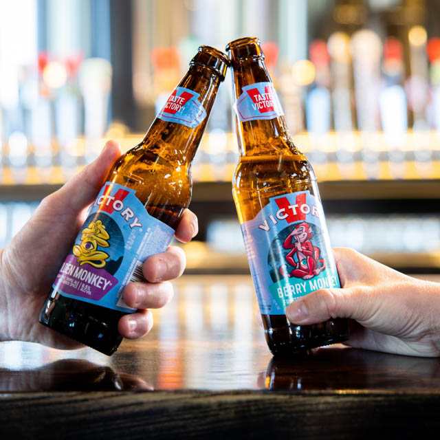 cheering with two beer glass bottles