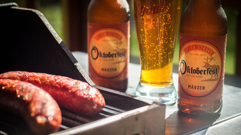 two beer bottles placed next grill