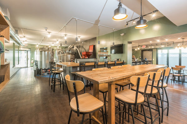 empty tables and chairs inside brewery