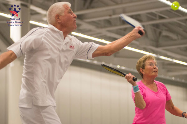 senior couple playing pickle ball