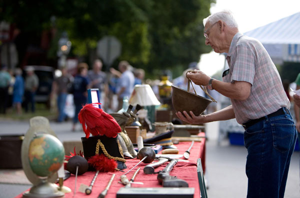 a person holding world war two soldier cap from crafts show