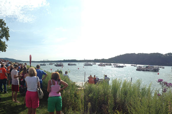 people watching boats on river