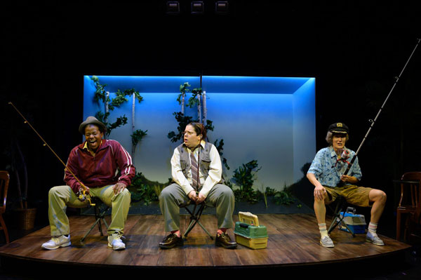 A group of men sitting on a stage