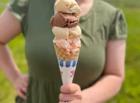 holding icecream in a waffle cone