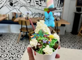 ice cream in a waffle cone with various toppings