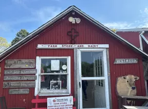 Red cabin the reads "Farm Store and Dairy"