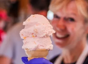 woman holding up ice cream cone