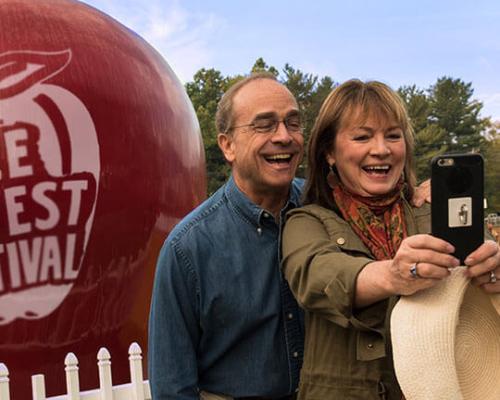 selfie in front of large apple